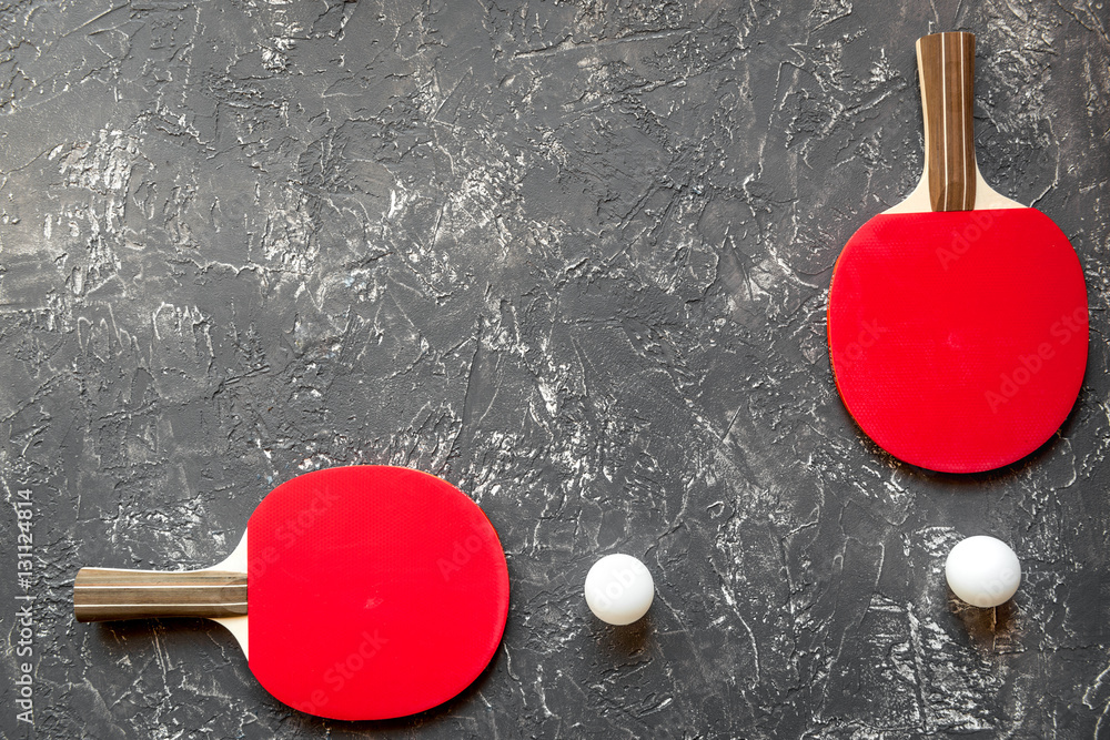 Red racket for ping pong ball gray background top view Red racket for ping pong ball gray background top view