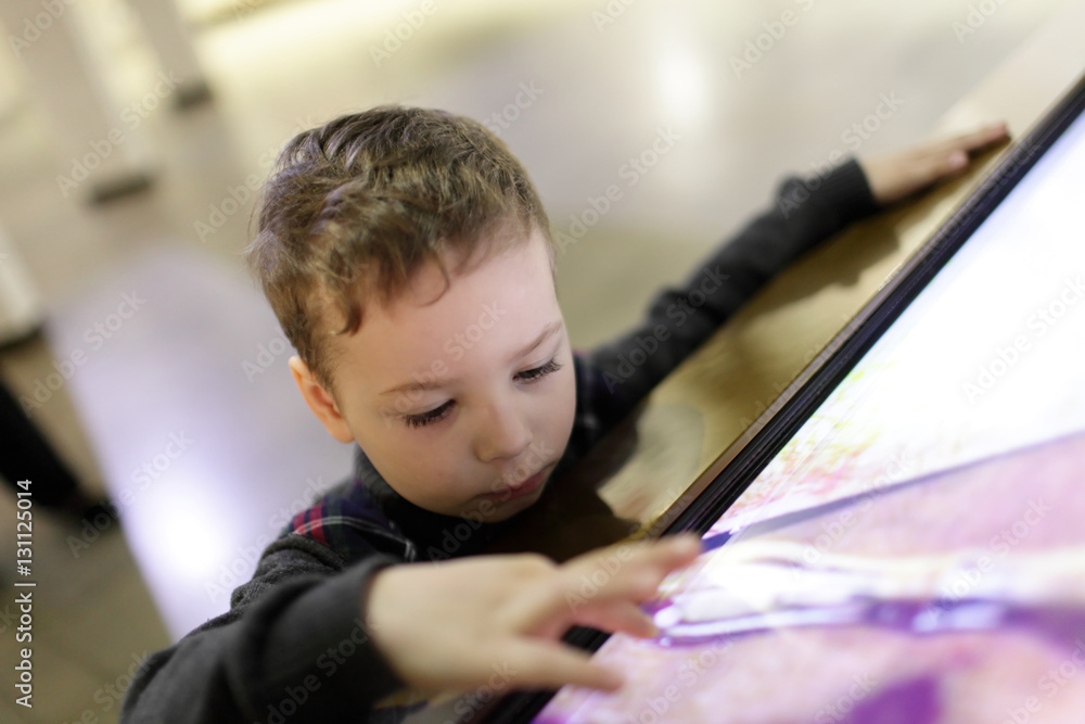 Kid using touch screen Kid using touch screen