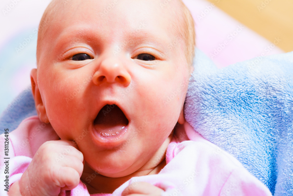 Newborn baby lying in pyjamas and towel Newborn baby lying in pyjamas and towel