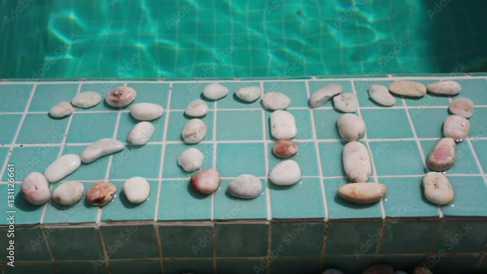 Inscription 2017 of pebble on a pool side Inscription 2017 of pebble on a pool side