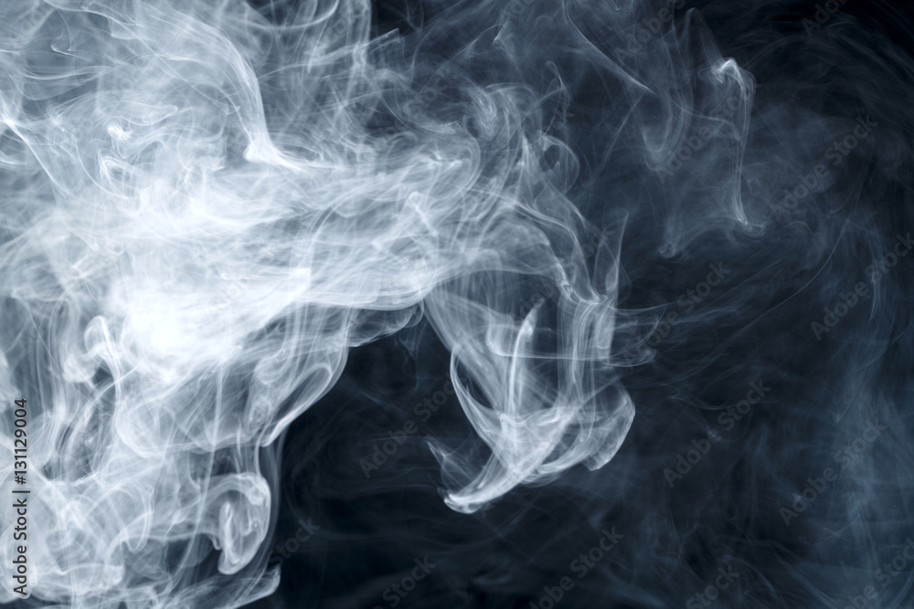 Obraz premium Abstract smoke Weipa. Personal vaporizers fragrant steam. The concept of alternative non-nicotine smoking. Blue smoke on a black background. E-cigarette. Evaporator. Taking Close-up. Vaping.