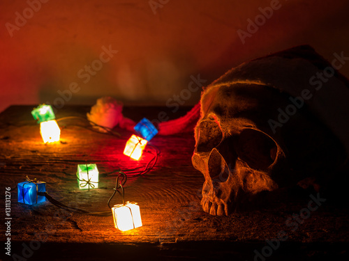 Still life skull wear santa claus hat with gift blinker light.