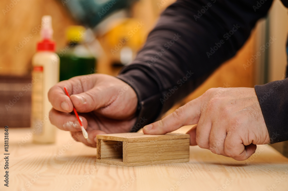 Carpenter hands glueing wood
