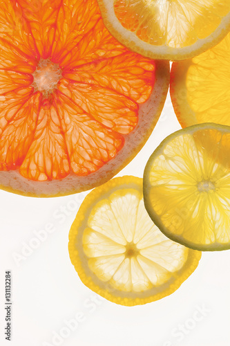 Sliced citrus fruit, white background  photo