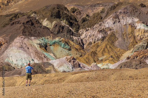 Men taking a picture of colored rocks 