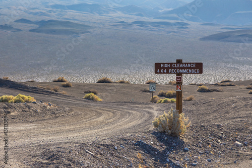 High clearance 4x4 recommendation sign and speed limit sign in Death Valley National Park, California, USA.