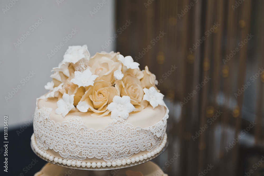 Wedding cake decorated with beige flowers from the cream 6720. Wedding cake decorated with beige flowers from the cream 6720.