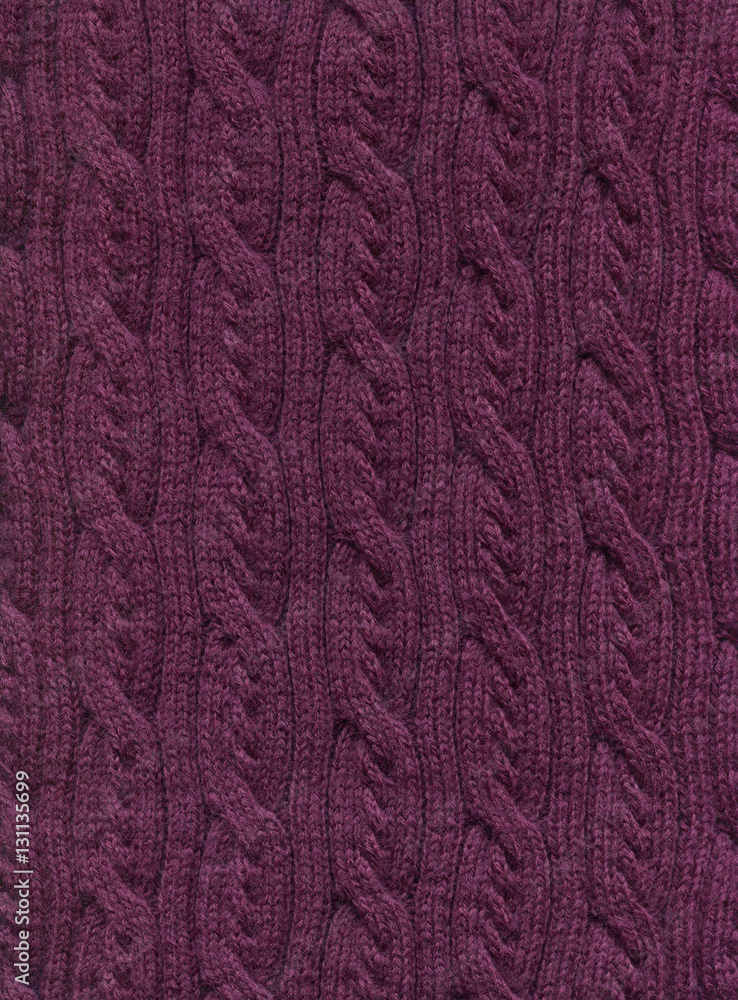Knitted fabric with a pattern of vertical braids.Decorative material, background, texture, wallpaper