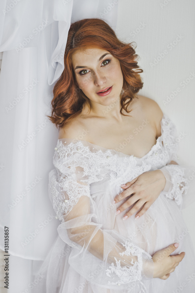 Red-haired pregnant girl in a white robe 6850. Red-haired pregnant girl in a white robe 6850.