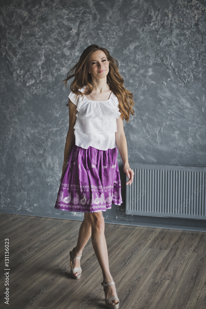 Portrait of a girl in full growth on a background of decorative Portrait of a girl in full growth on a background of decorative