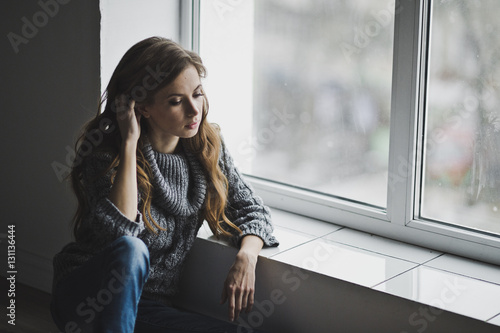 Free Download The girl is sitting by the large window 6998. - GFXLoad