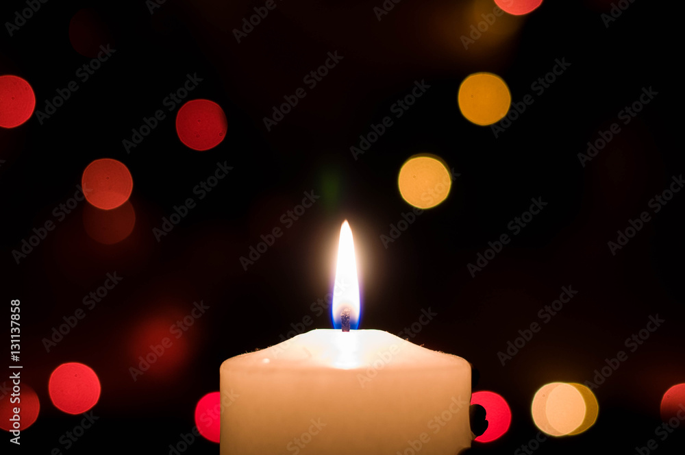Warm christmas candle with garlands in a wreath Warm christmas candle with garlands in a wreath