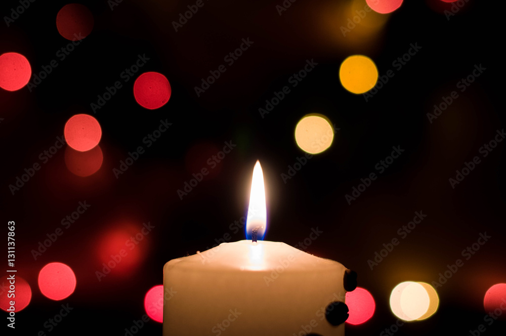 Warm christmas candle with garlands in a wreath Warm christmas candle with garlands in a wreath