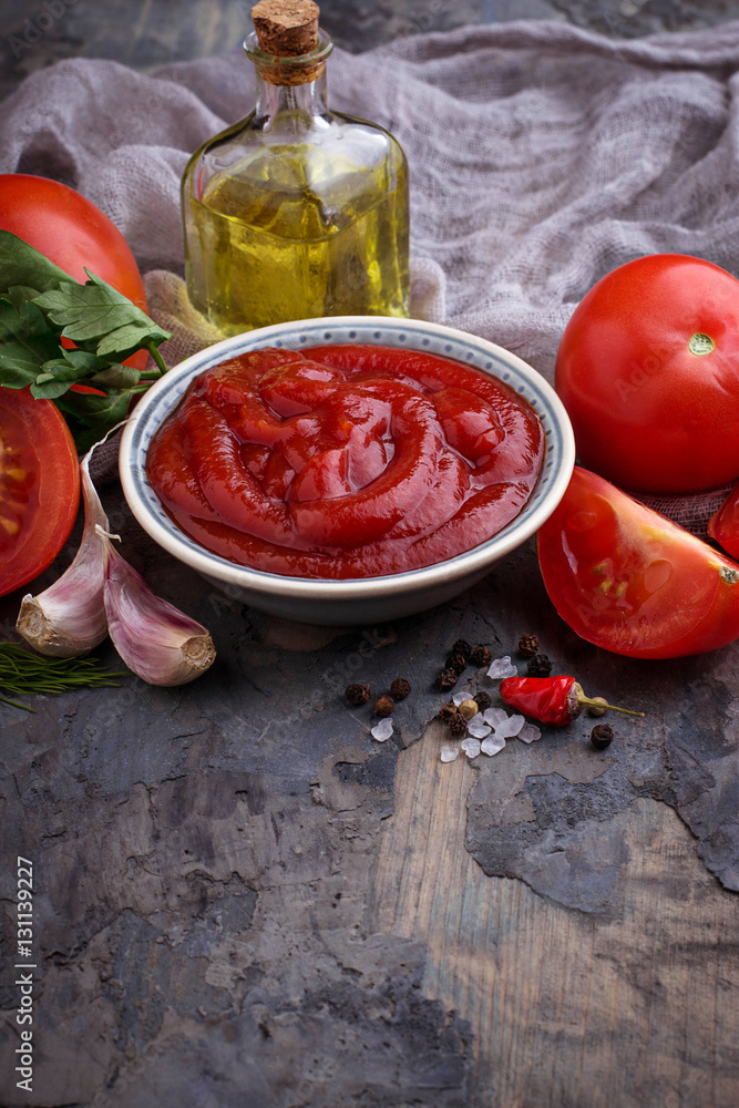 Tomato ketchup sauce on concrete background Tomato ketchup sauce on concrete background