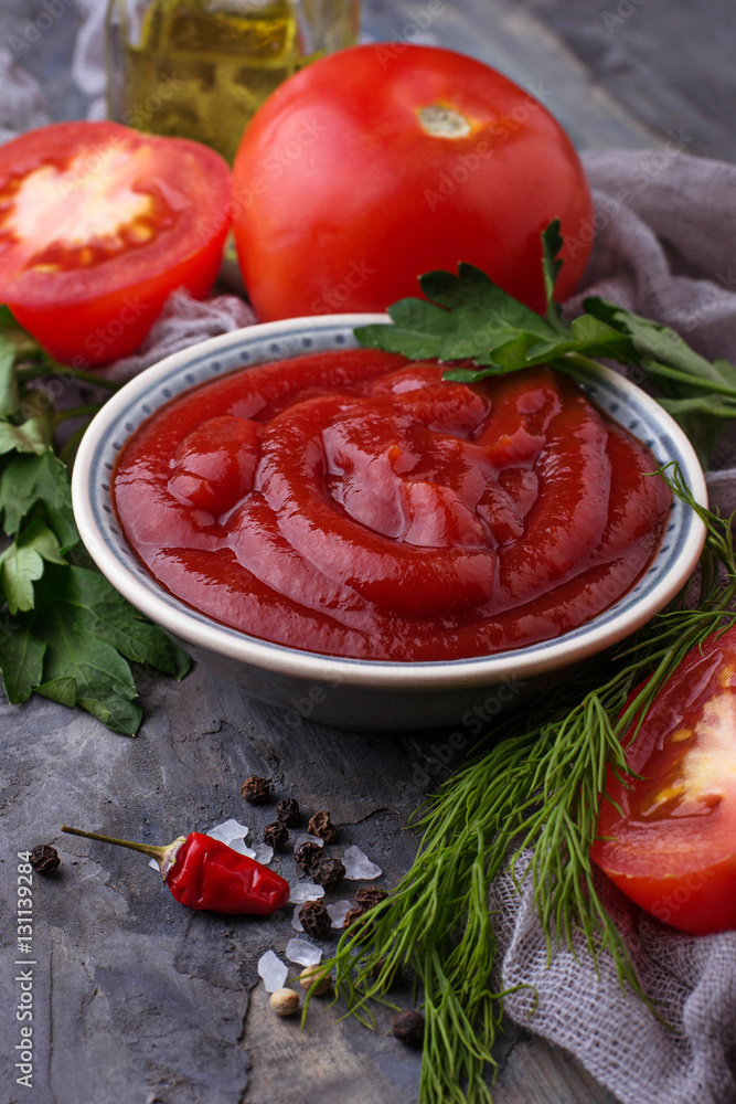 Tomato ketchup sauce on concrete background Tomato ketchup sauce on concrete background