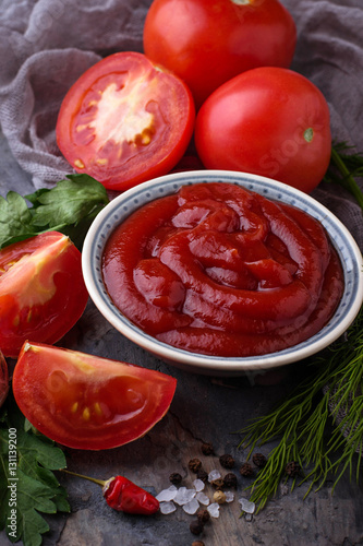 Tomato ketchup sauce on concrete background