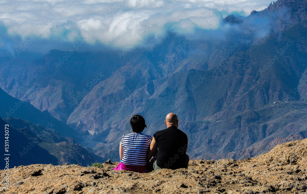 Couple enjoying beautiful view in the mountains