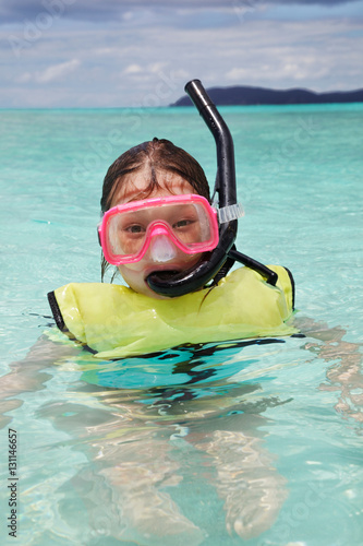 Young girl treads water in snorkeling gear, St. John