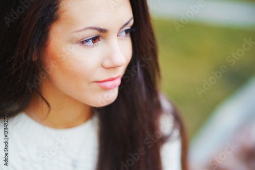 Portrait of young beautiful long-haired women brunettes on blurred background, closeup