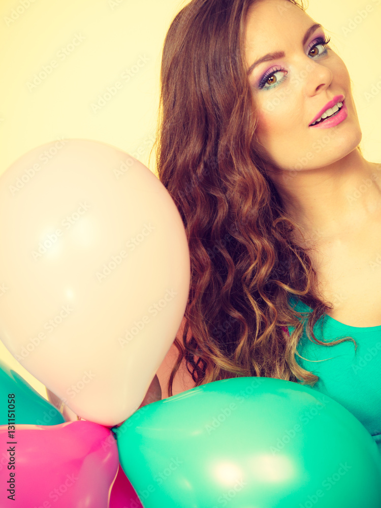 Woman holding bunch of colorful balloons Woman holding bunch of colorful balloons