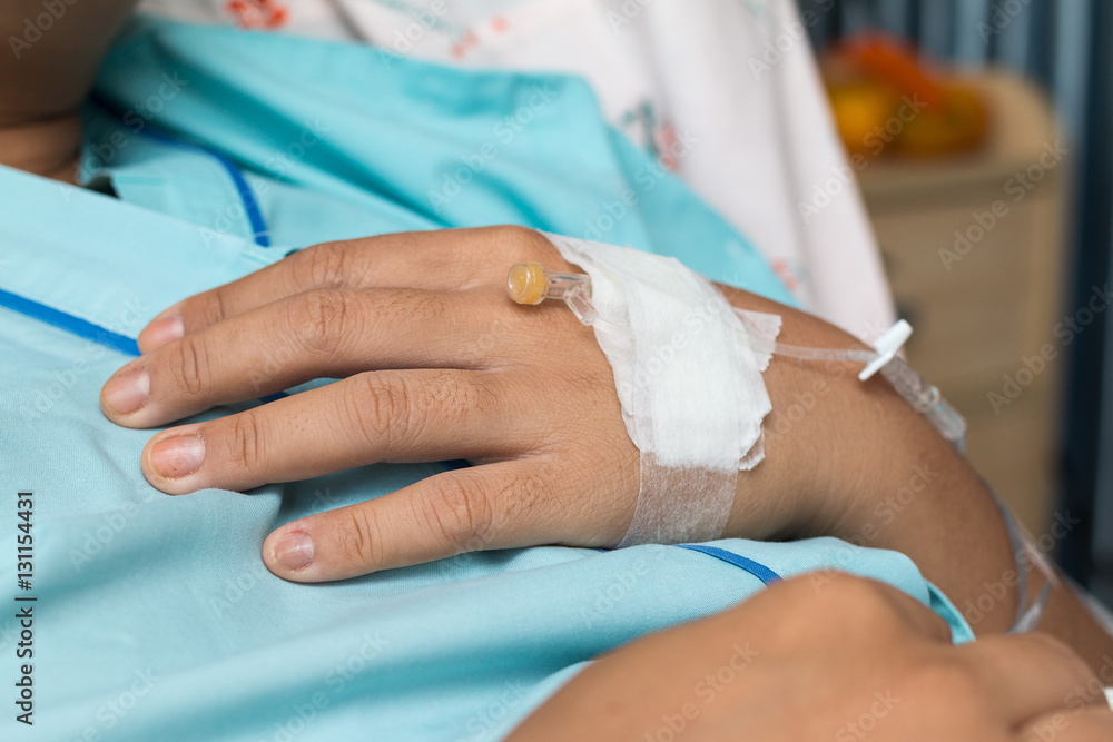 Focus on the hand of a patient in hospital ward Focus on the hand of a patient in hospital ward
