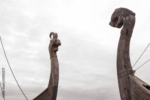 Viking warship at a shadow in the background of cloudy sky