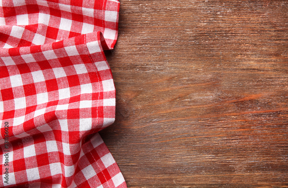 Obraz premium Red napkin on wooden table