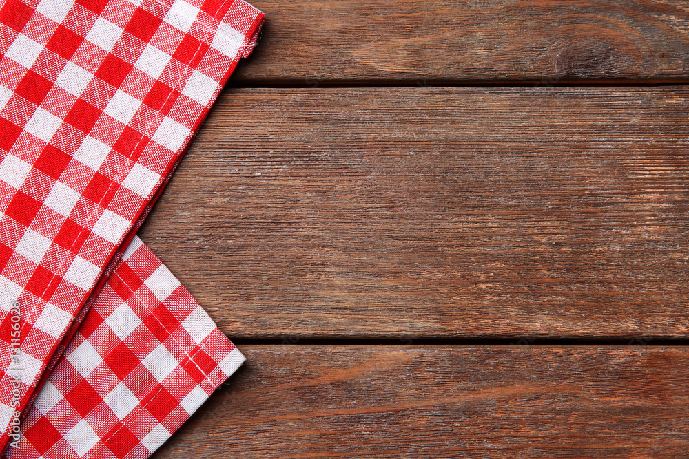 Red napkin on wooden table Red napkin on wooden table