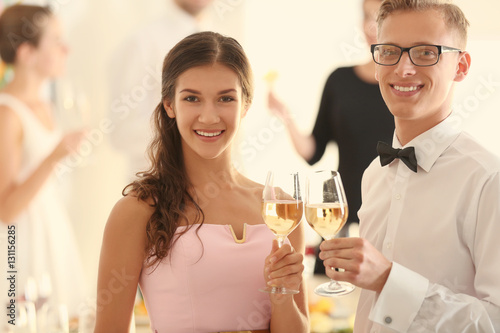 Young man and woman with gl...