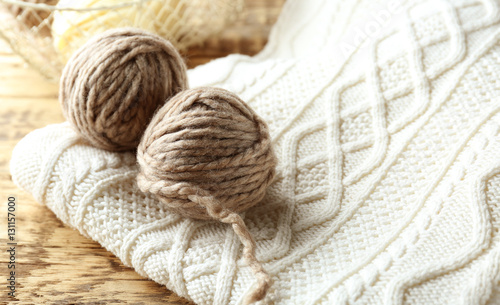 Grey balls of knitting yarn on knitwear, closeup