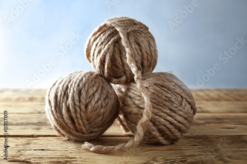 Balls of knitting yarn on wooden table