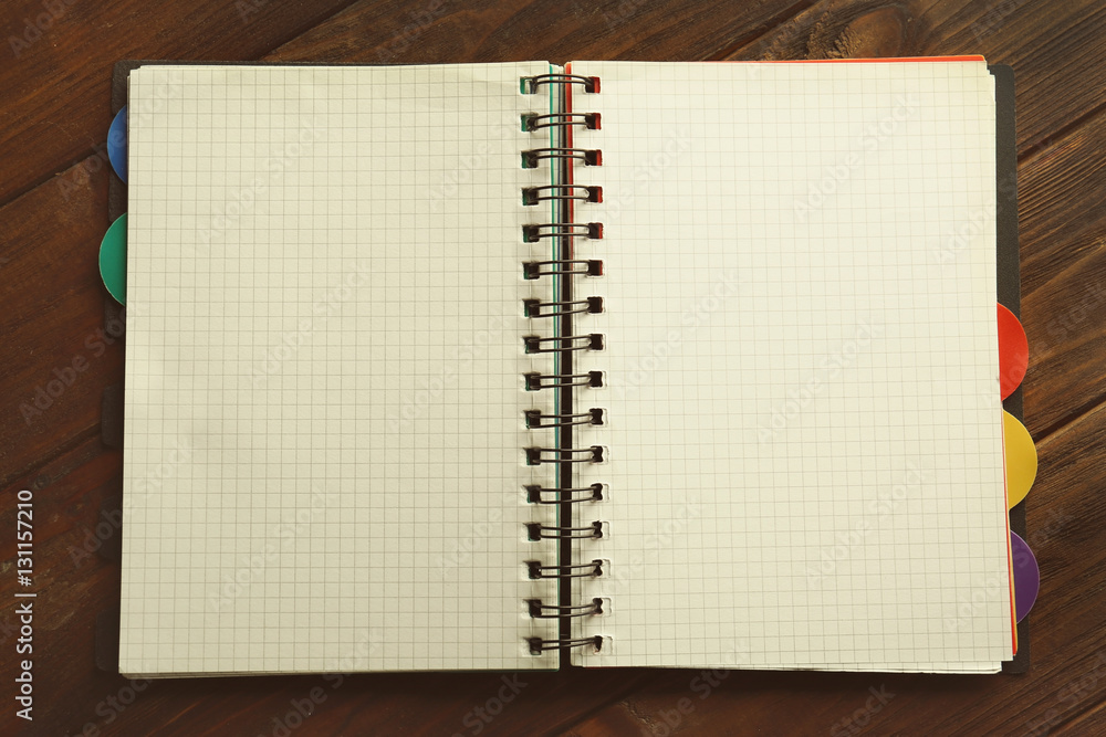 Opened notebook on wooden background Opened notebook on wooden background