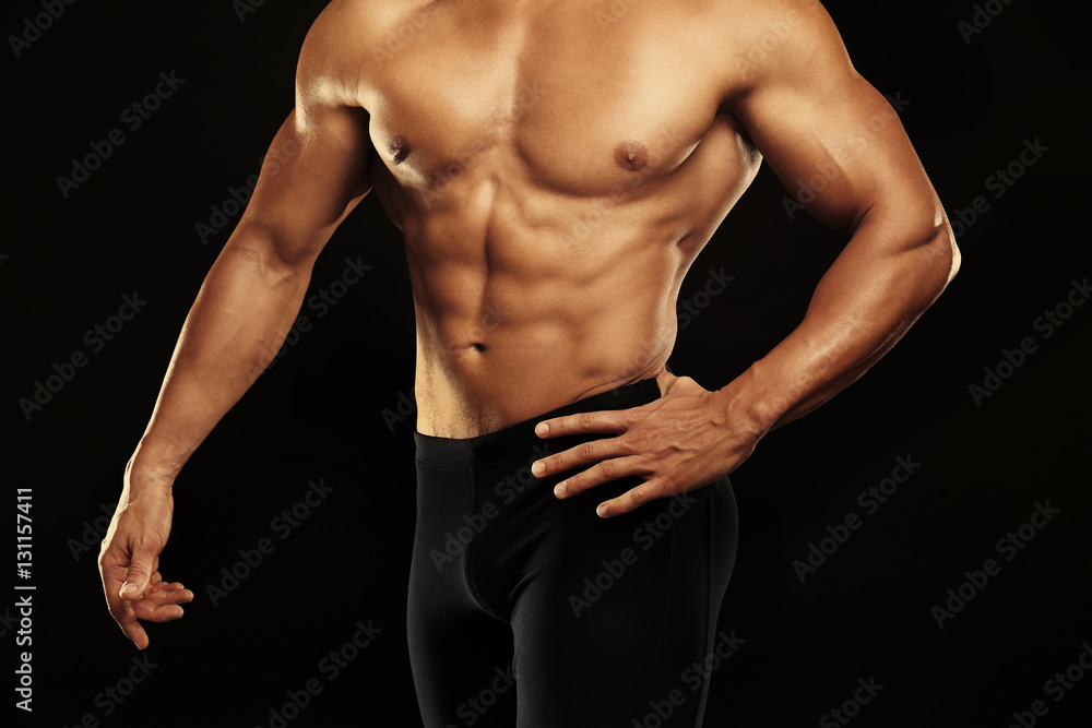 Sporty young man on black background, closeup Sporty young man on black background, closeup