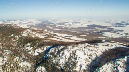 Russian Ural mountains in winter. Aerial view lake, white infinity photo