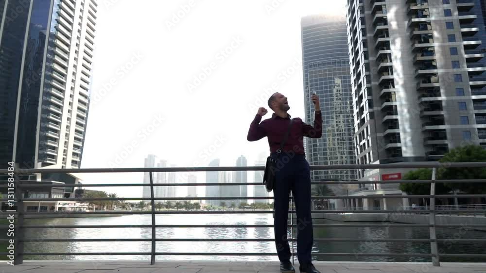 Successful businessman with smartphone standing by river in city, super slow motion 240fps
Successful businessman with smartphone standing by river in city, super slow motion 240fps