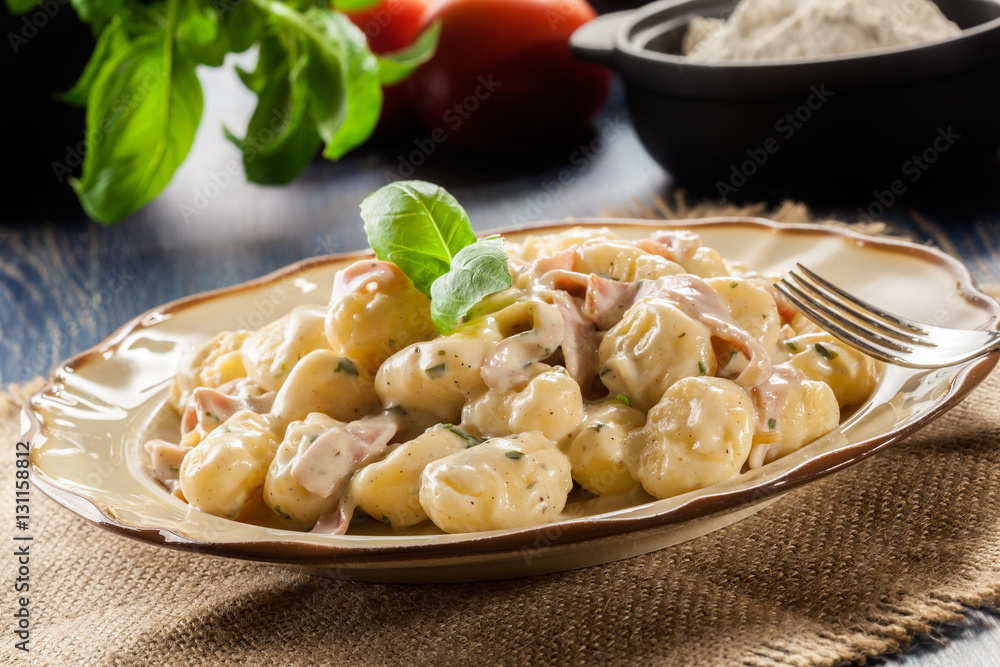 Potato gnocchi, Italian potato dumplings with cheese sauce, ham Potato gnocchi, Italian potato dumplings with cheese sauce, ham