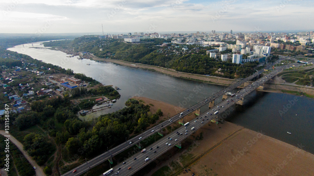 Autumn in city. Panoramic aerial view at road, forest, river.