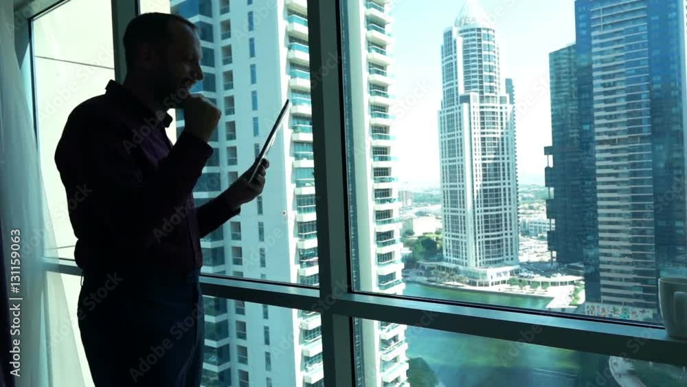 Successful businessman with tablet standing by window in office, super slow motion 240fps
Successful businessman with tablet standing by window in office, super slow motion 240fps