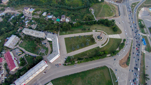 Autumn in city. Panoramic aerial view at road, forest, river.