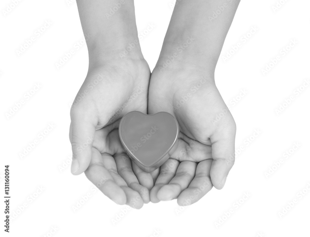 Obraz premium Heart care, medical concept. Heart in the hands of a child. Black and white image