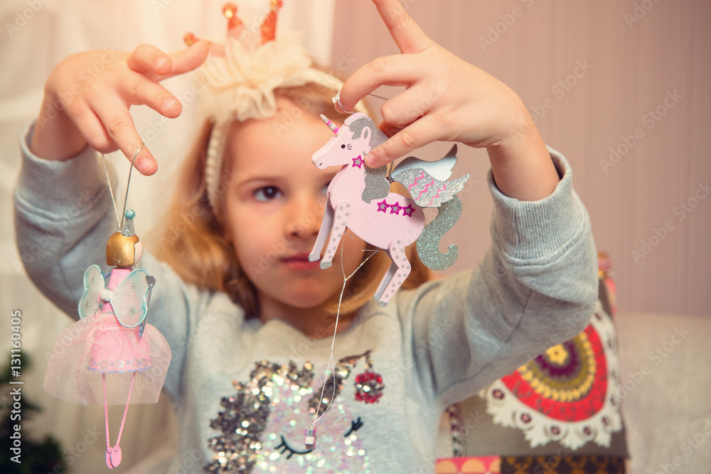 Little girl with Christmas ornaments and gifts Little girl with Christmas ornaments and gifts