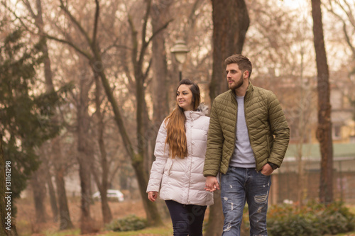 Young couple walking winter autumn day
