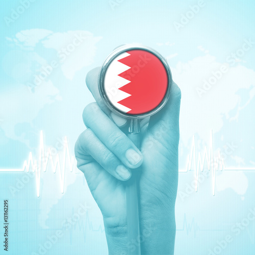 hand holding stethoscope with Bahrain flag.