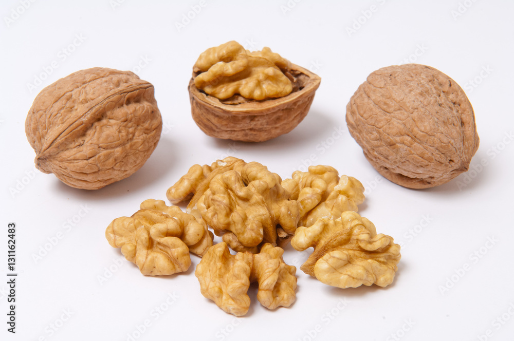 Walnuts and walnut kernels on white background Walnuts and walnut kernels on white background