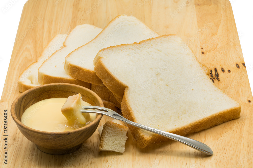 Portion of bread dip in sweetened condensed milk Portion of bread dip in sweetened condensed milk