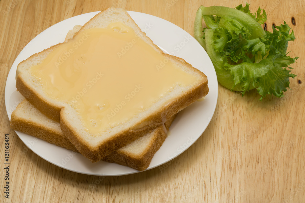 Breads and sweetened condensed milk in a white plate