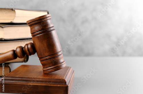Judge's gavel and books on wall background