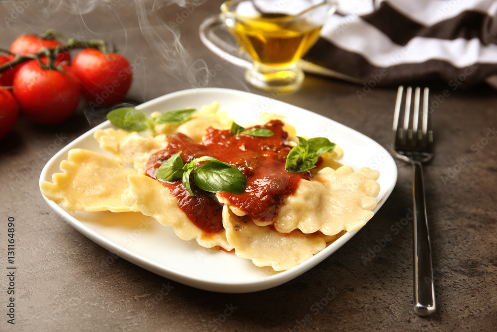 Plate of ravioli with tomato sauce on table Plate of ravioli with tomato sauce on table