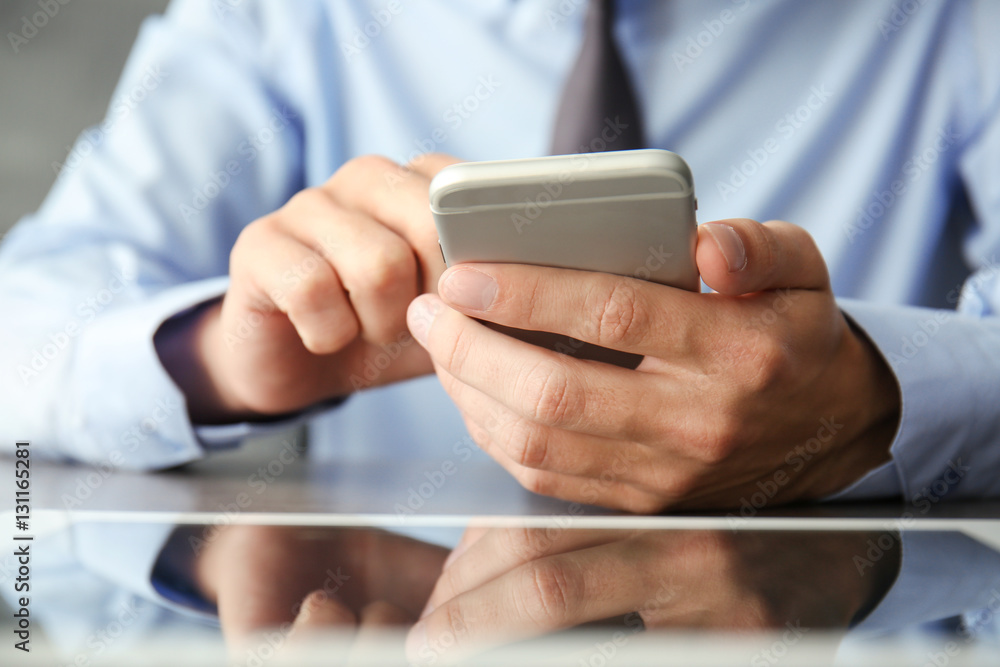 Businessman using phone on table Businessman using phone on table