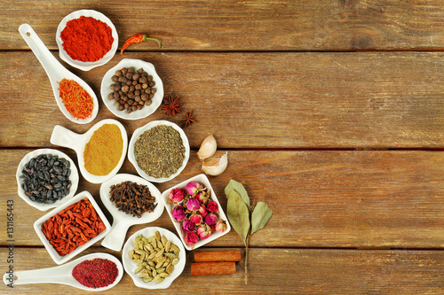 Aromatic spices on wooden background